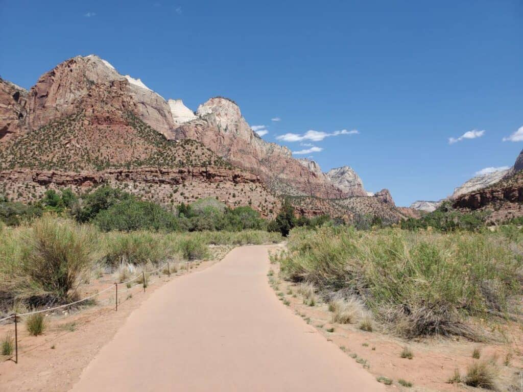 This 2 day Zion itinerary includes the Pa'rus Trail, where this paved path runs along the river with canyon walls in the distance.